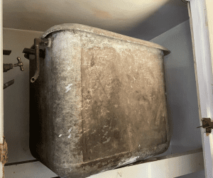 Asbestos cement water tank in the cupboard of a domestic property 